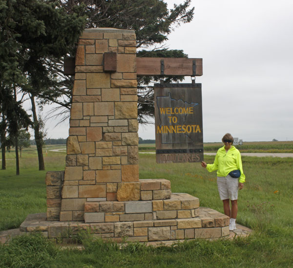 Kathy at the "Welcome to Minnesota" sign. 