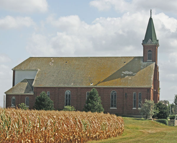 A weathered country chuch in the cornfields. 