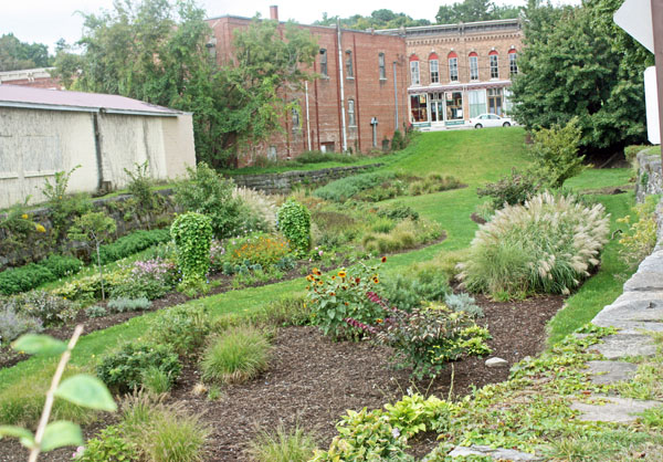 a canal bed planted with grass and flowers.
